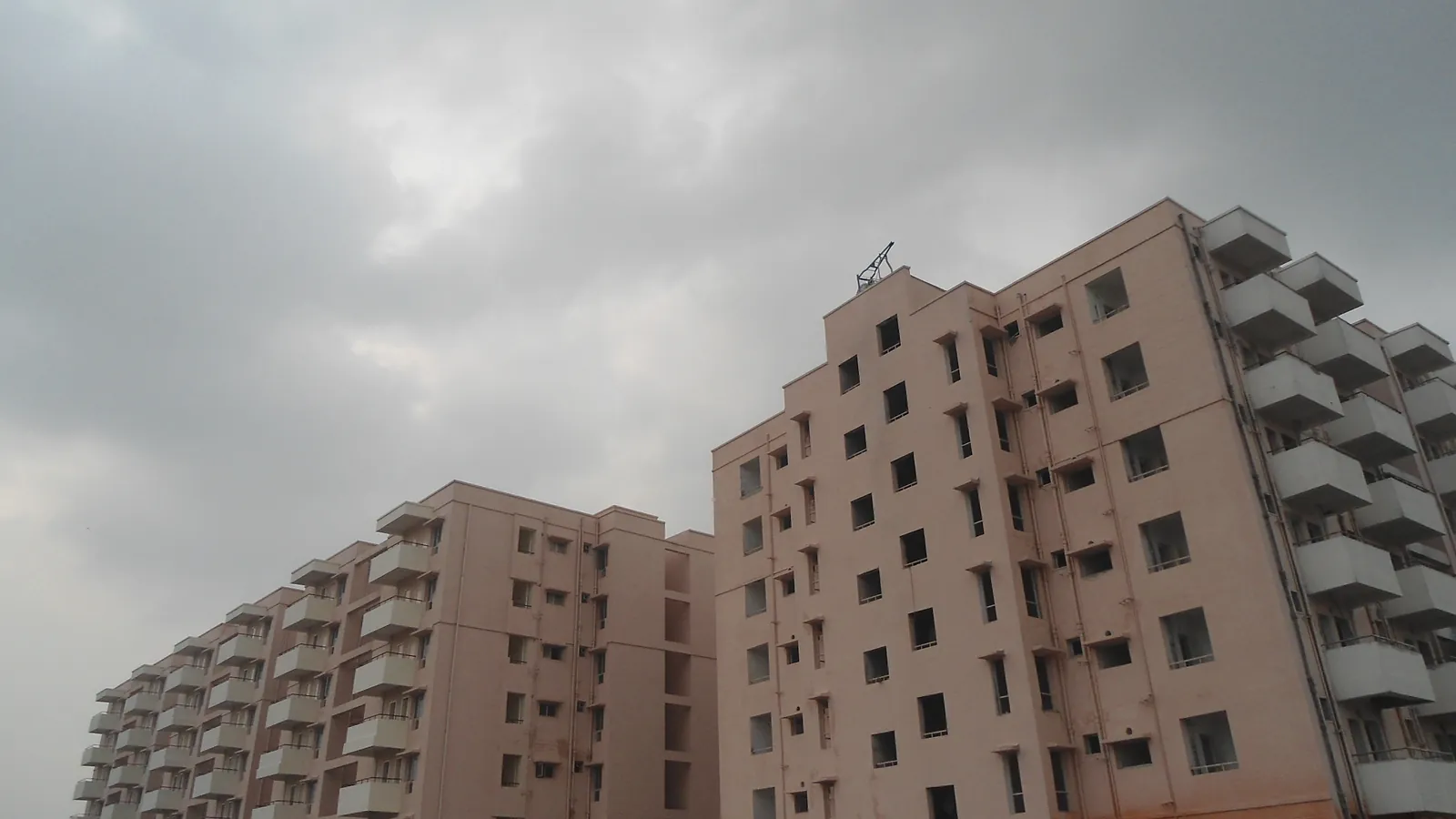 A newly built residential apartment complex under a cloudy sky