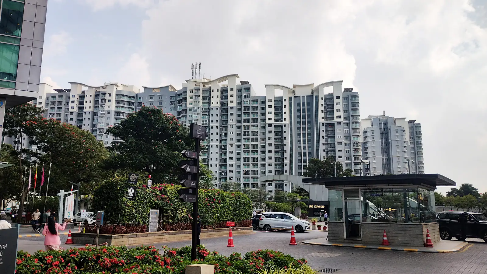 A gated residential complex in Rajajinagar, Bengaluru, with apartment towers rising behind a landscaped entrance