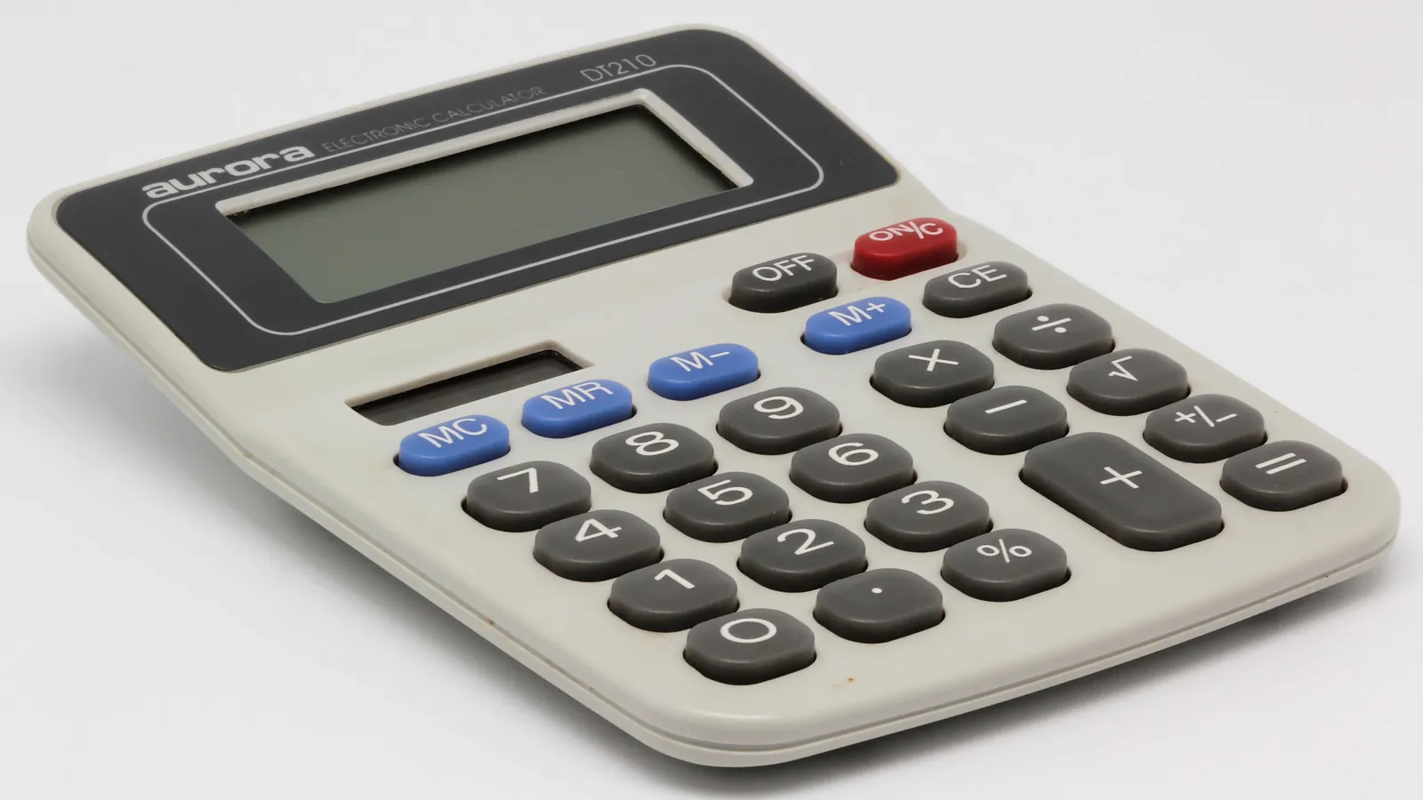 A desktop calculator photographed at an angle on a white background